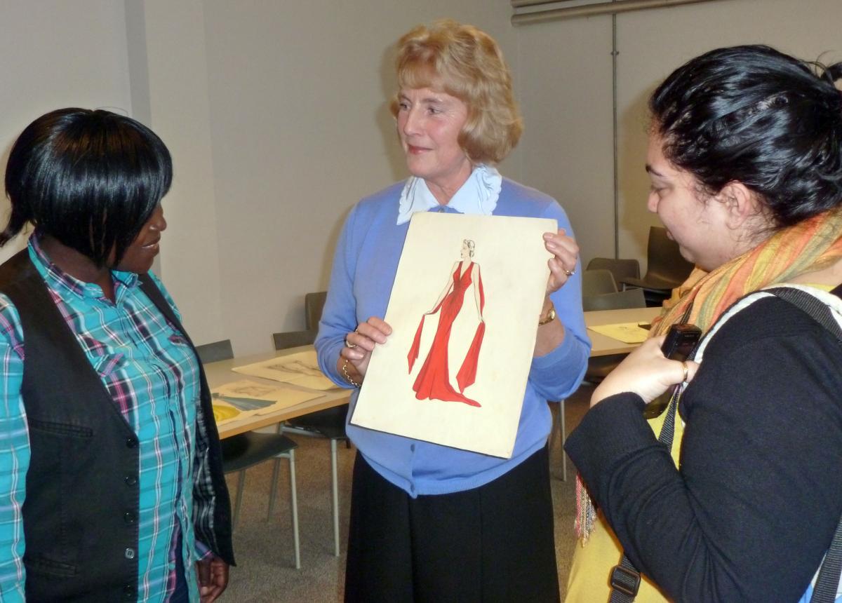 Wendy Mann shows fashion students one of her mother's designs